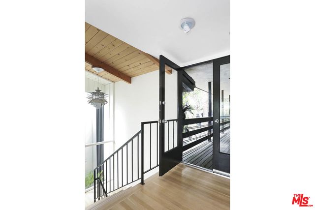 a view of staircase with white walls and a window