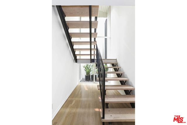 a spacious bedroom with a bed and a large window