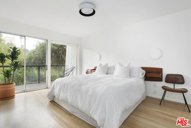 a bedroom with a large bed and a large window