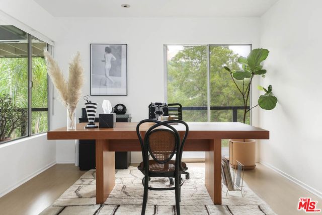 a balcony with wooden floor and chair