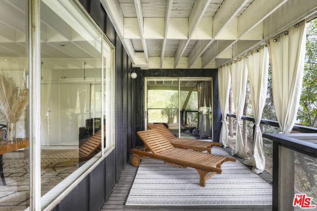 a spacious bedroom with a bed and a flat screen tv