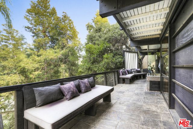 a kitchen with stainless steel appliances granite countertop a stove top oven a sink a dining table and chairs