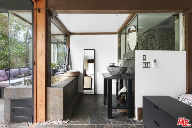 a picture of a livingroom with furniture and a fireplace