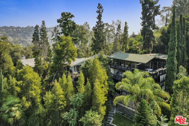 a backyard of a house with barbeque oven table and chairs