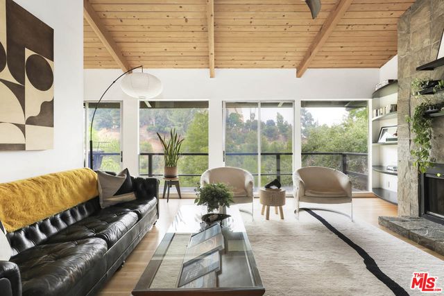 a living room with furniture and a floor to ceiling window