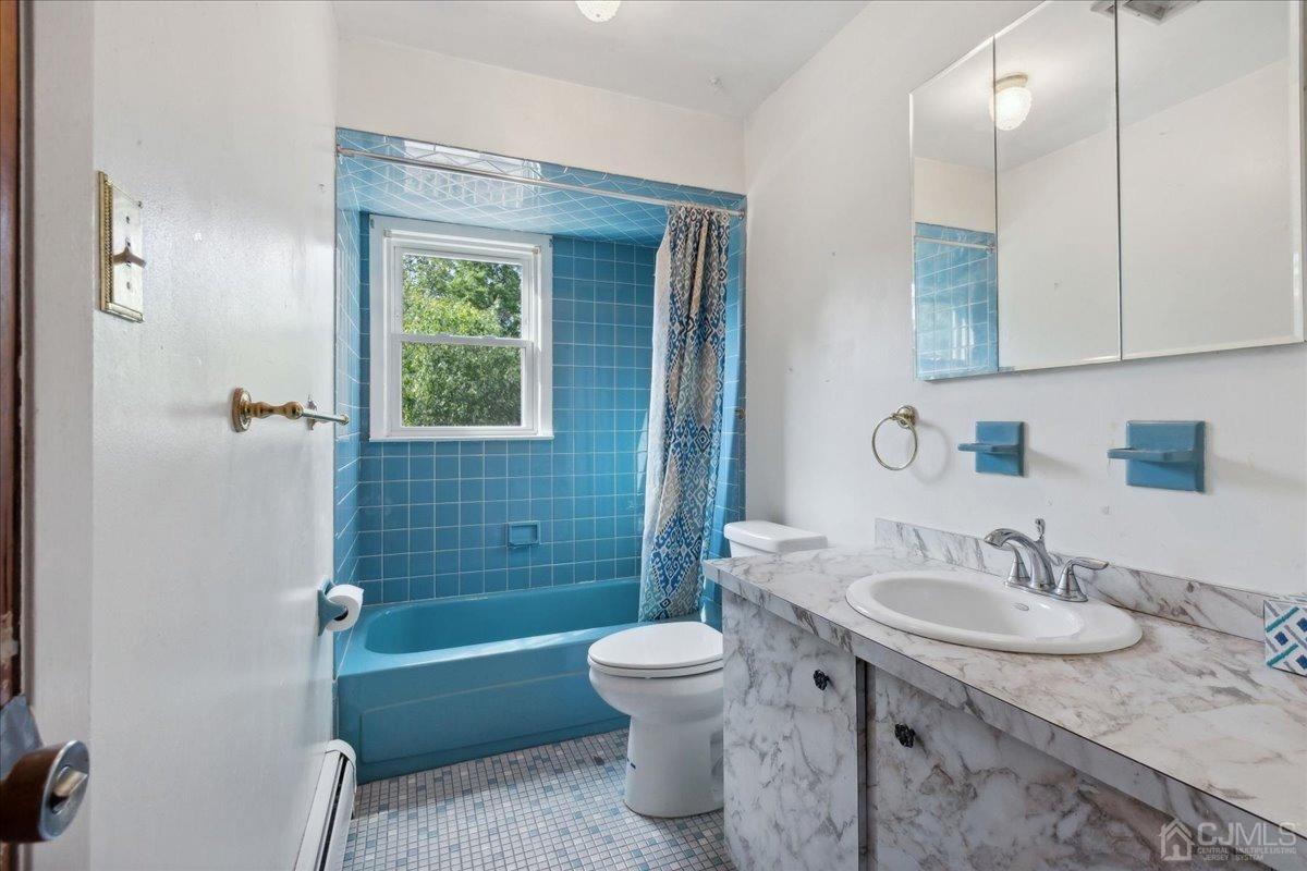 15 Weiss Drive Middlesex, NJ 08846 - Photo 12 of 33 a bathroom with a granite countertop sink toilet a shower and a mirror