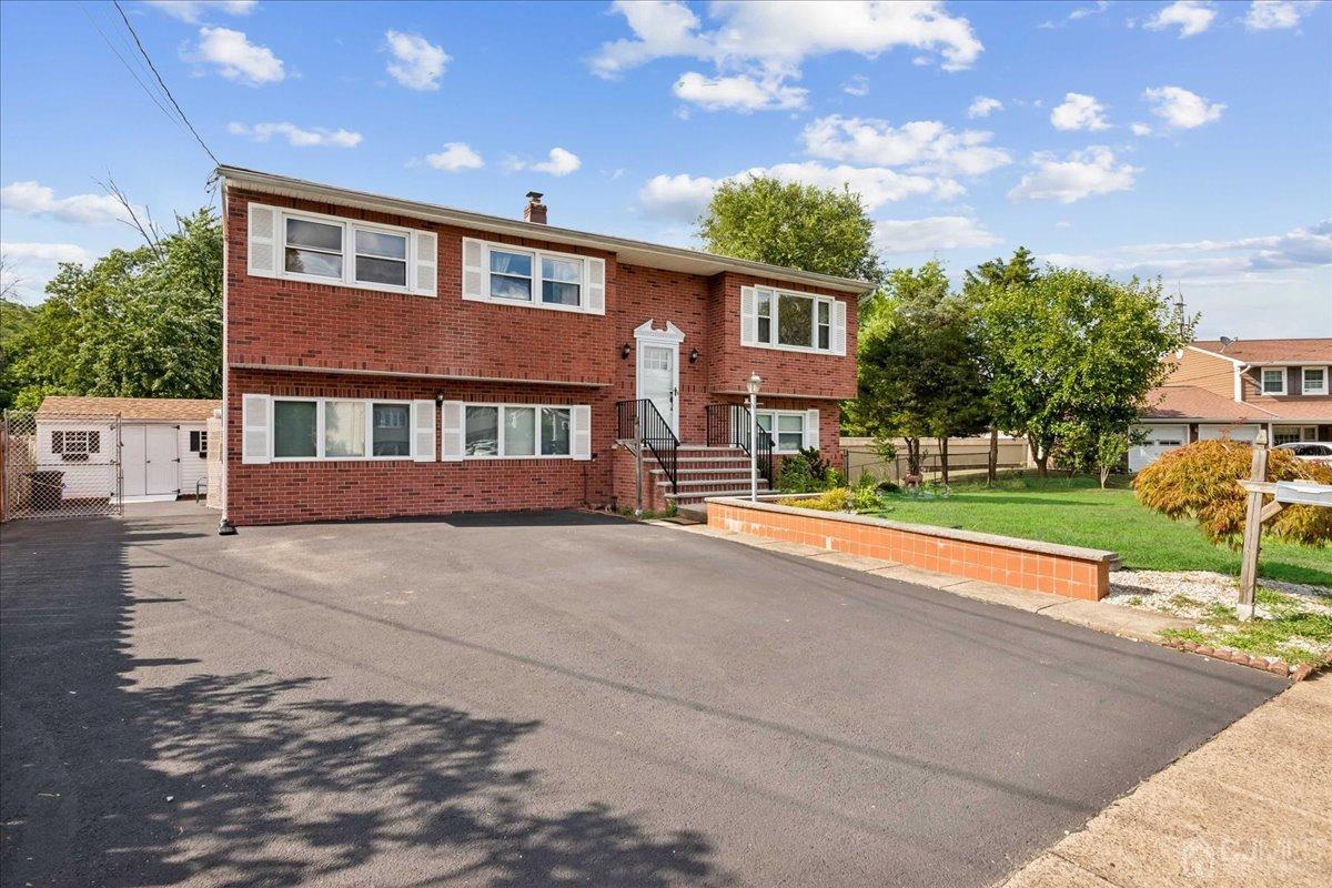 15 Weiss Drive Middlesex, NJ 08846 - Photo 2 of 33 a front view of a house with a yard and garage