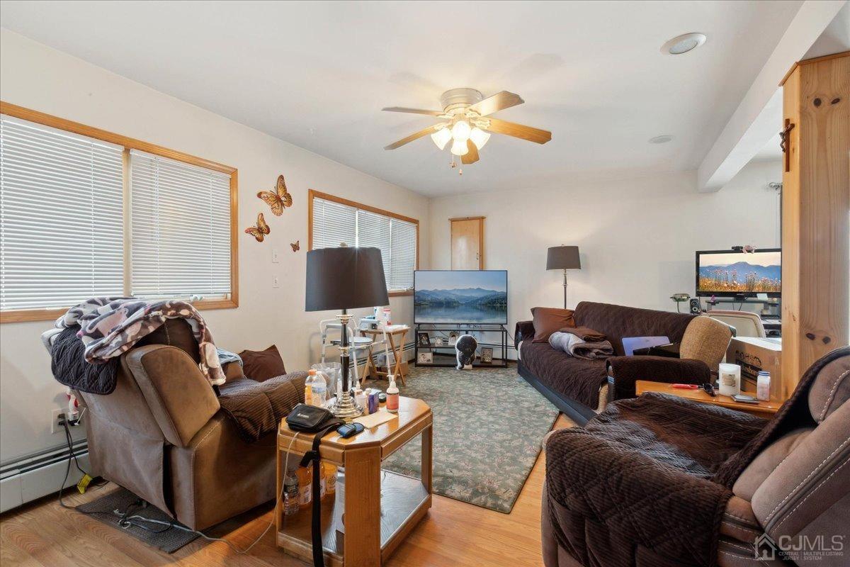 15 Weiss Drive Middlesex, NJ 08846 - Photo 21 of 33 a living room with furniture a fireplace and a flat screen tv