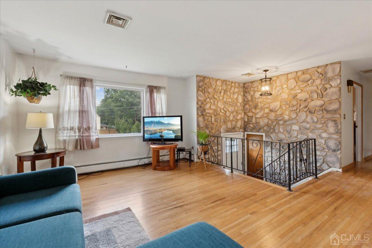 15 Weiss Drive Middlesex, NJ 08846 - Photo 8 of 33 a living room with furniture and a flat screen tv