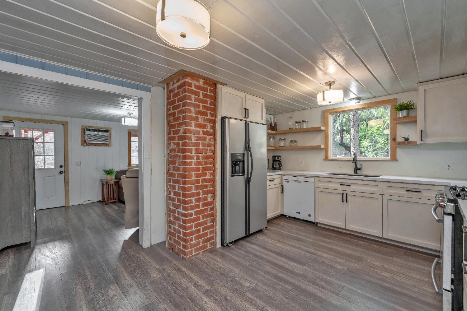5921 Bear Creek Road Garden Valley, CA 95633 - Photo 13 of 55 a kitchen with cabinets and wooden floor