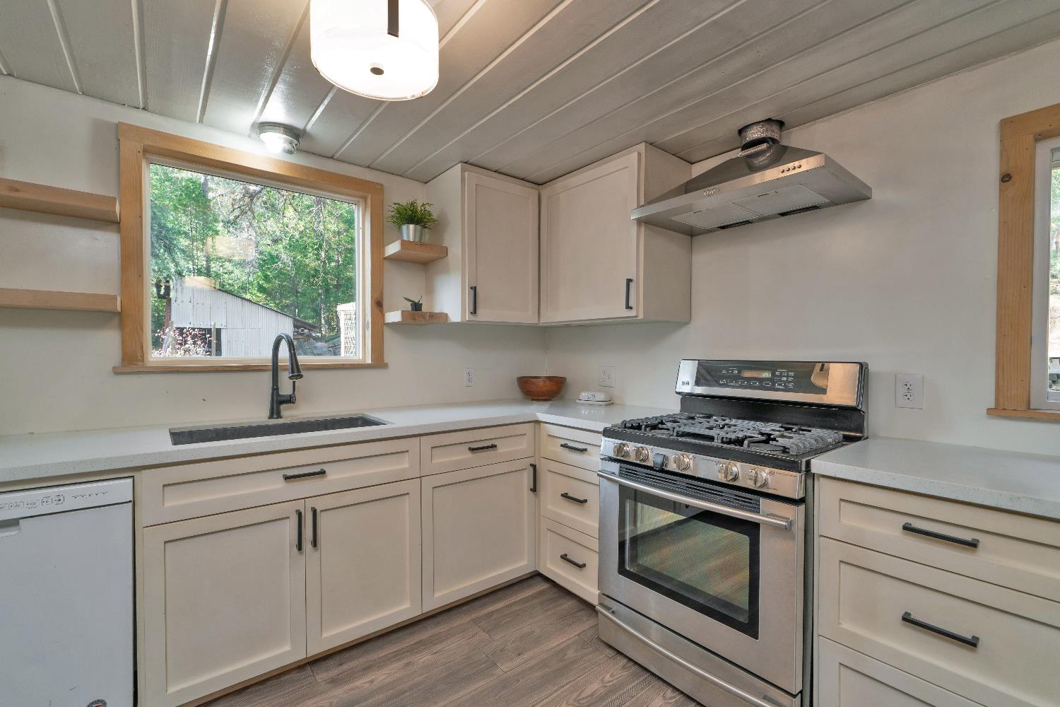 5921 Bear Creek Road Garden Valley, CA 95633 - Photo 15 of 55 a kitchen with cabinets appliances and a window