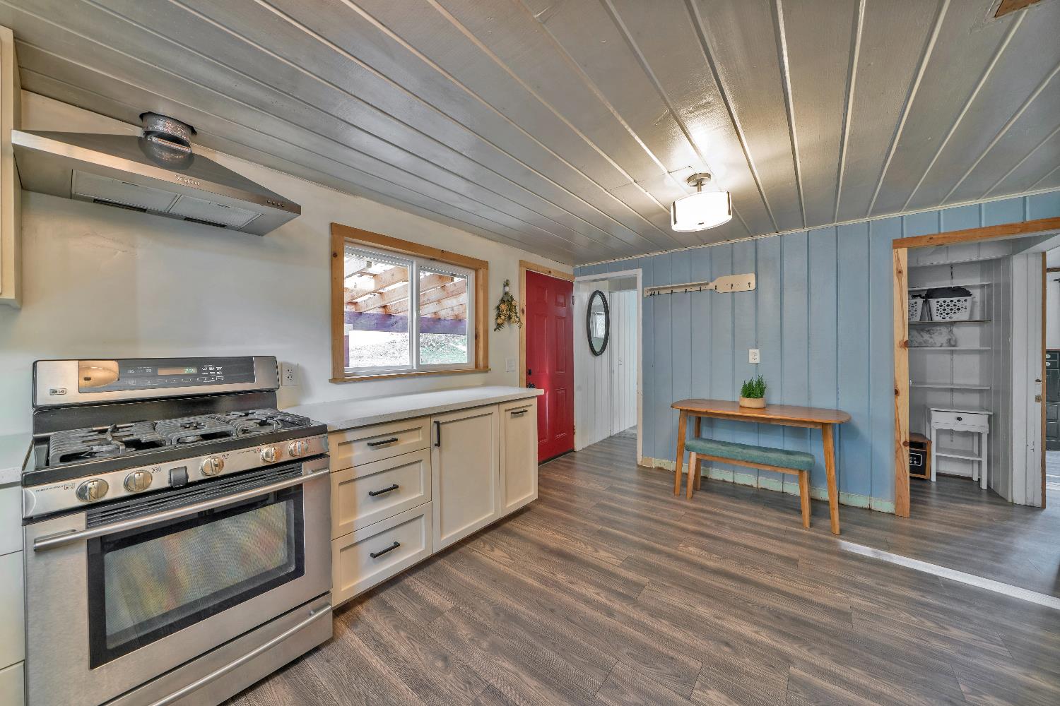 5921 Bear Creek Road Garden Valley, CA 95633 - Photo 17 of 55 a kitchen with furniture wooden floor and a stove top oven