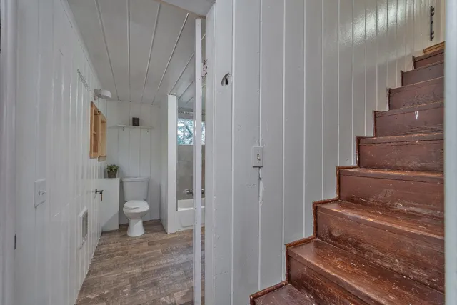 a bathroom with a toilet and a bathtub
