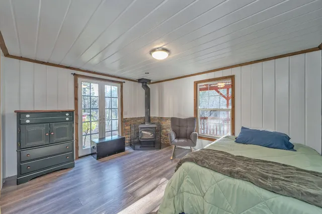 a bedroom with a bed and a mirror