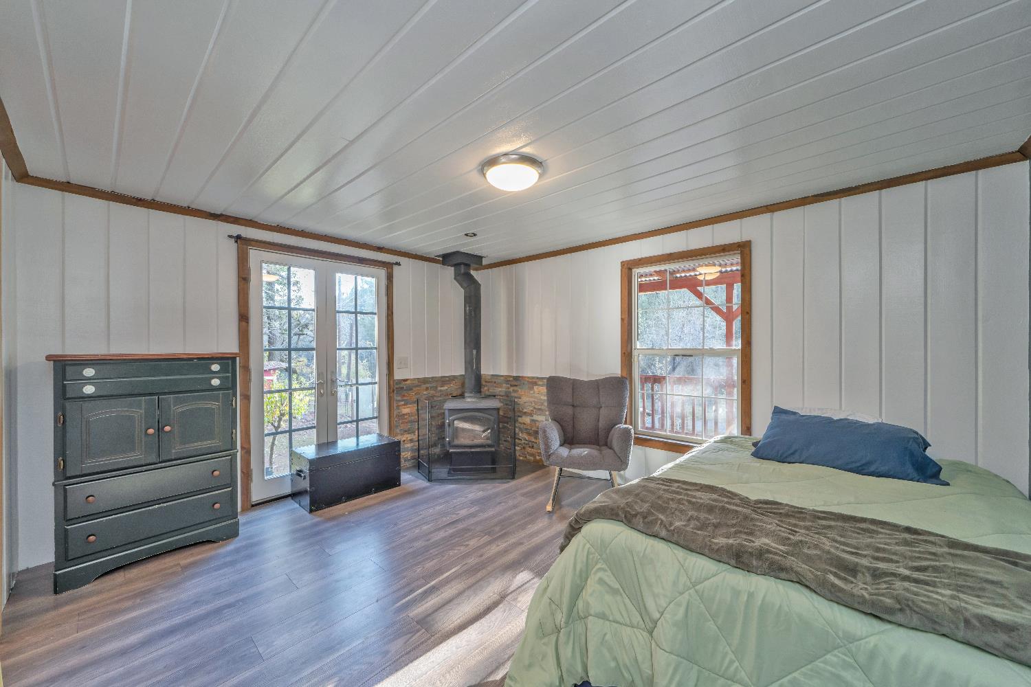 5921 Bear Creek Road Garden Valley, CA 95633 - Photo 22 of 55 a bedroom with a bed and wooden floor