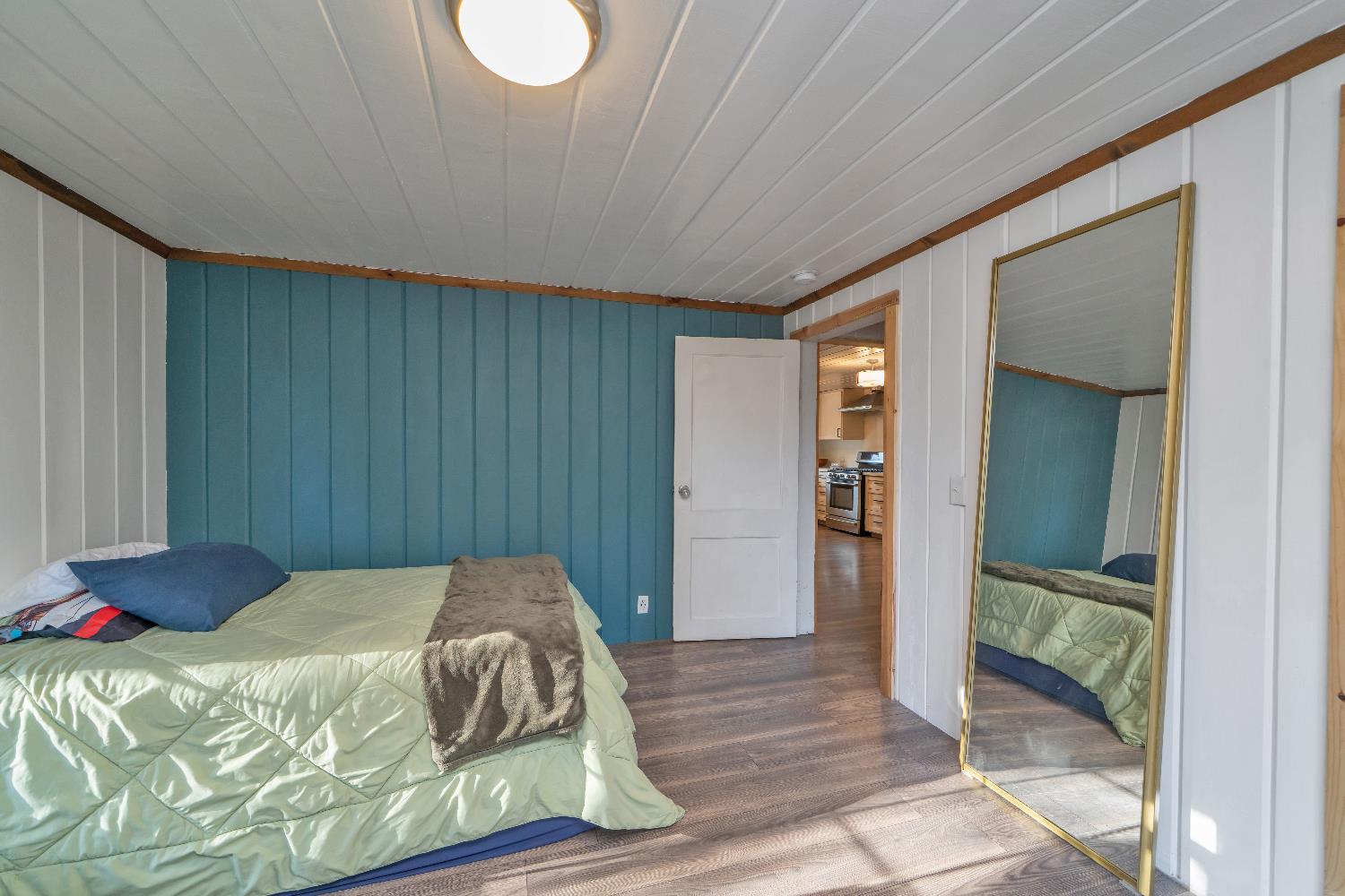 5921 Bear Creek Road Garden Valley, CA 95633 - Photo 23 of 55 a bedroom with a bed and a mirror