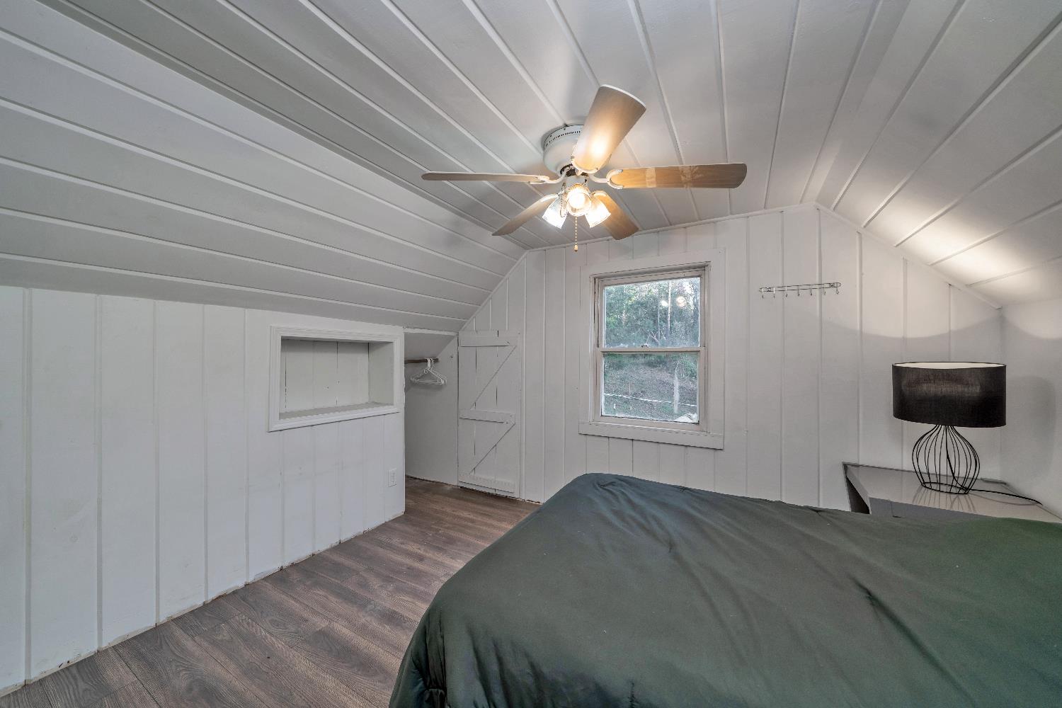 5921 Bear Creek Road Garden Valley, CA 95633 - Photo 26 of 55 a bedroom with a bed and a chandelier