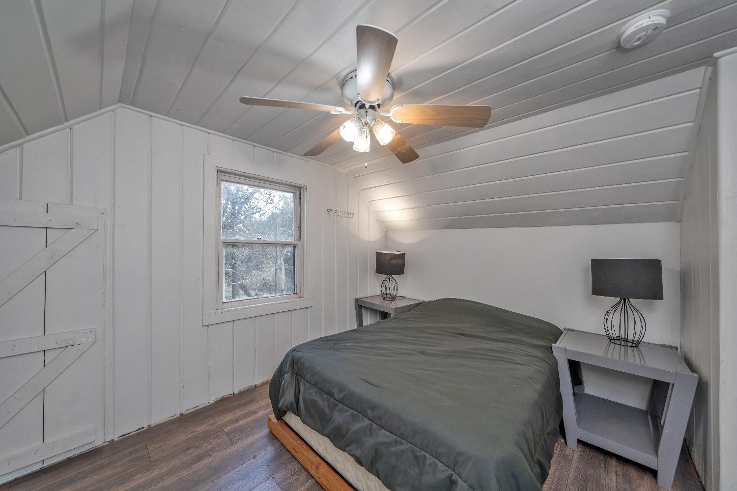 5921 Bear Creek Road Garden Valley, CA 95633 - Photo 27 of 55 a bedroom with a bed and a chandelier