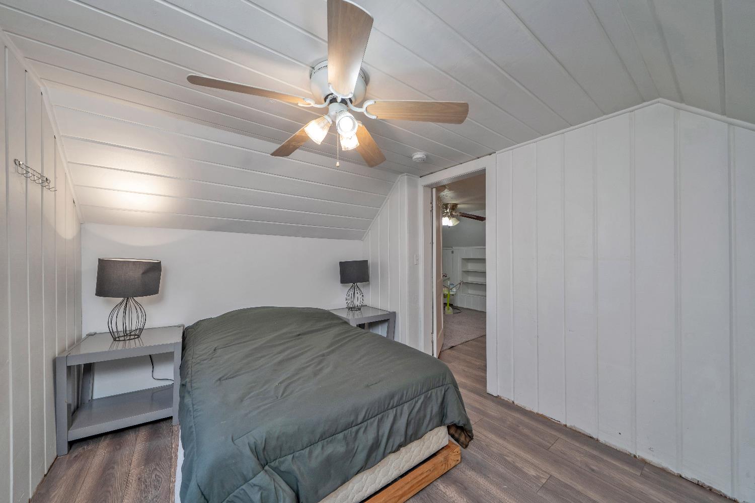 5921 Bear Creek Road Garden Valley, CA 95633 - Photo 28 of 55 a bedroom with a bed and a chandelier