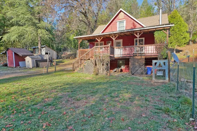 a view of a house with a yard and sitting area