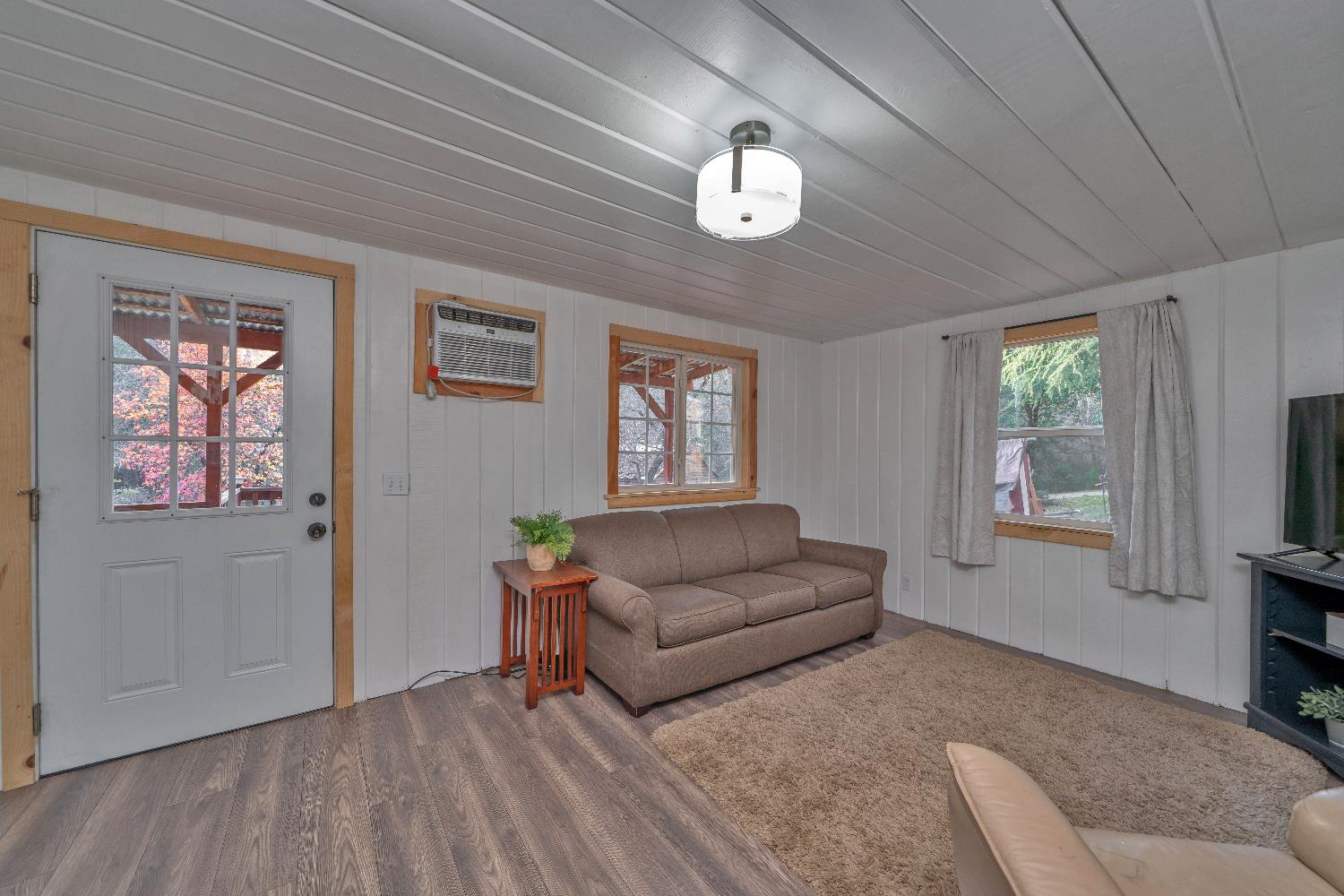 5921 Bear Creek Road Garden Valley, CA 95633 - Photo 4 of 55 a living room with furniture and a flat screen tv