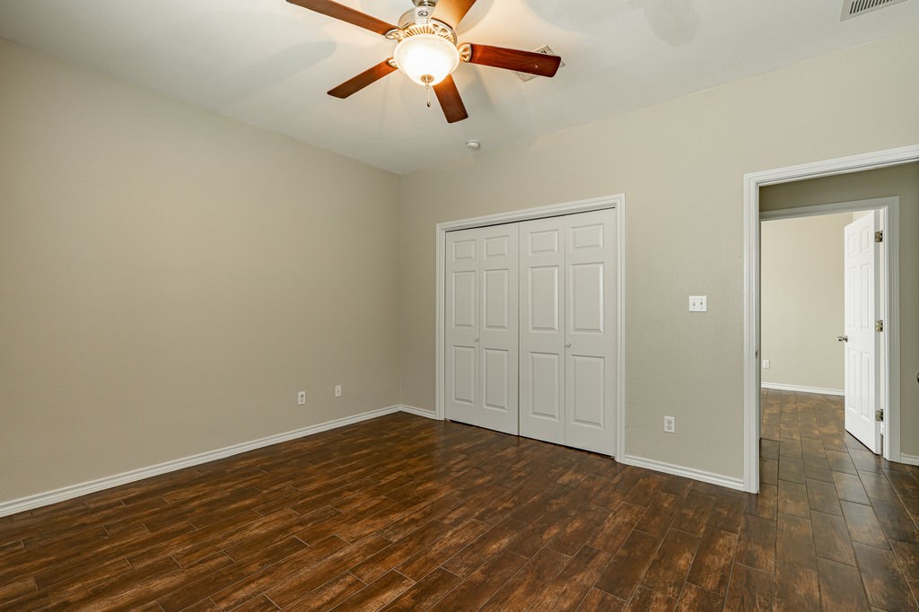 6007 Fairway Street, Unit C Austin, TX 78741 - Photo 16 of 22 an empty room with wooden floor and windows