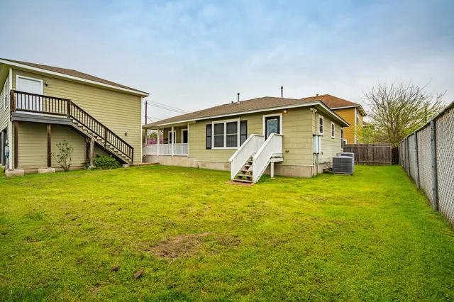 a view of a house with a yard and sitting area