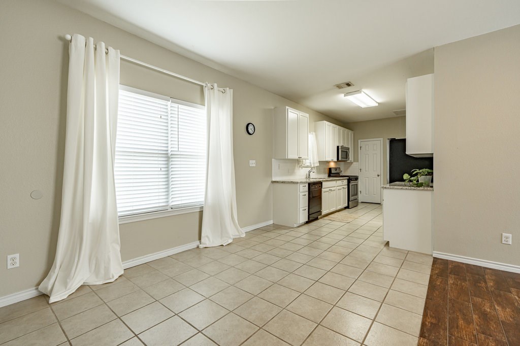 6007 Fairway Street, Unit C Austin, TX 78741 - Photo 8 of 22 a kitchen with stainless steel appliances granite countertop a refrigerator and a sink