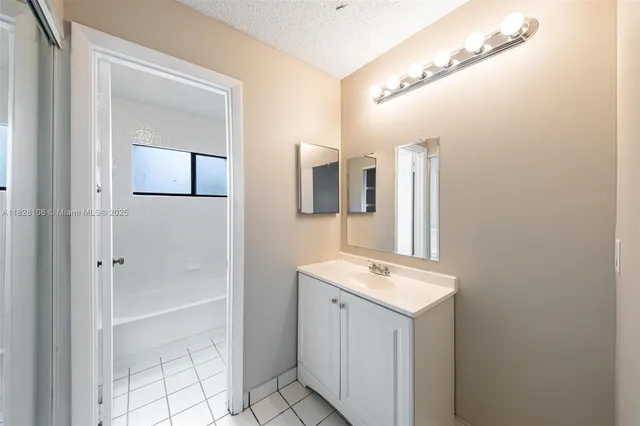 a bathroom with a sink a mirror and a shower
