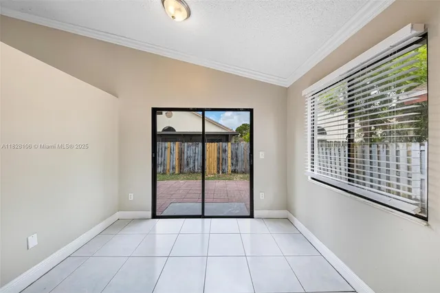 a view of an empty room with glass door