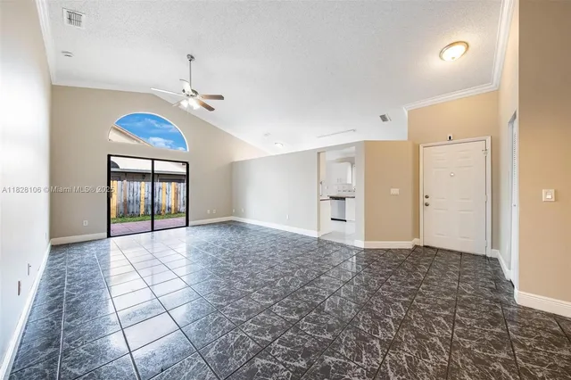 a view of a room with an entryway and chandelier