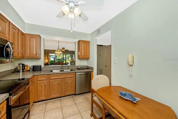 a kitchen with a refrigerator sink and stove