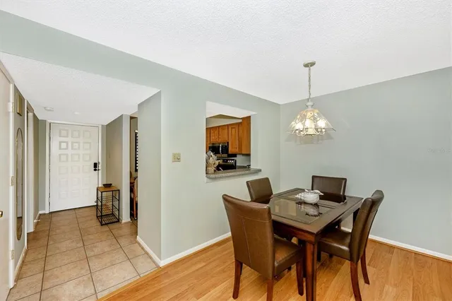 a spacious bedroom with a bed and a potted plant on the dresser