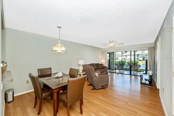 a bedroom with a bed a chandelier and a dresser