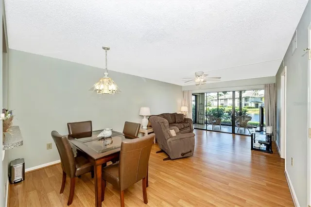a bedroom with a bed a chandelier and a dresser