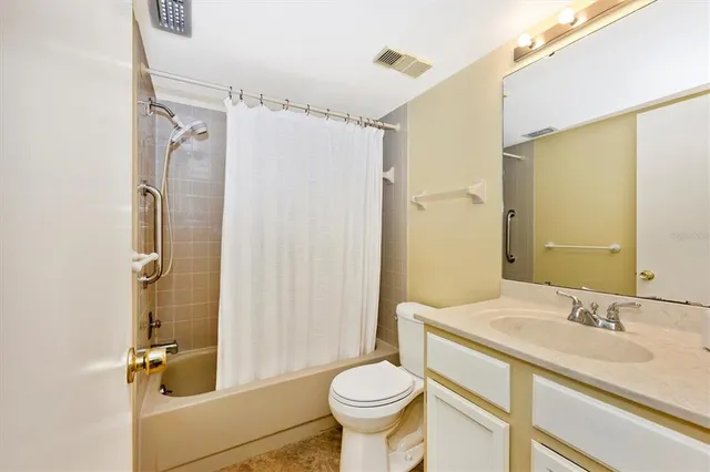 a living room with furniture and a large window with wooden floor