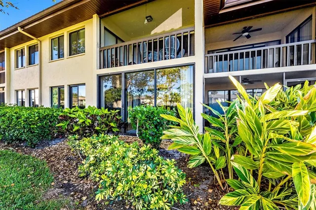 a view of a patio with table and chairs and potted plants