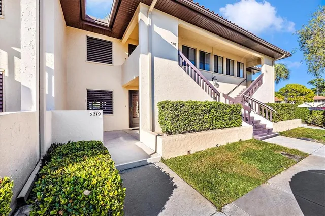 a view of a swimming pool with a deck and dining room