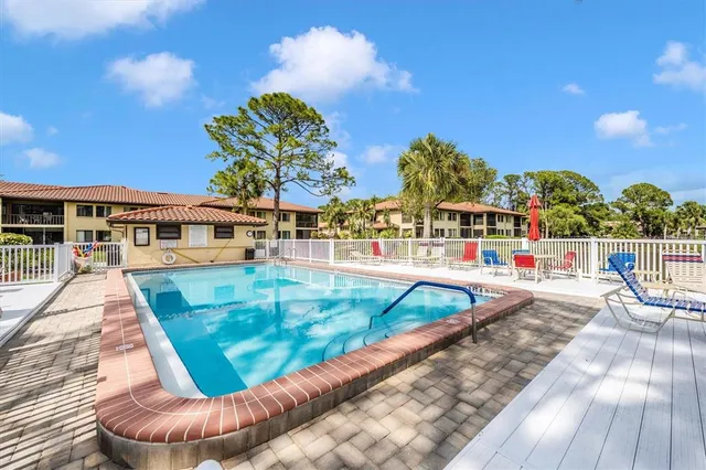 a view of a cars park in front of a building