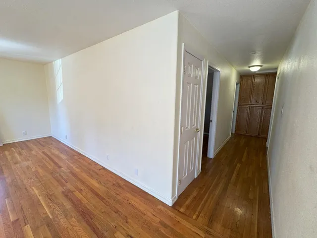 a view of hallway with wooden floor