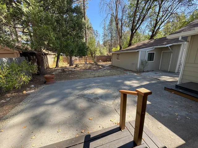 a backyard of a house with yard and tree