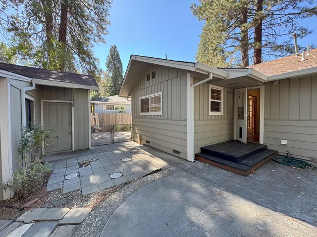 a view of a small house with a yard