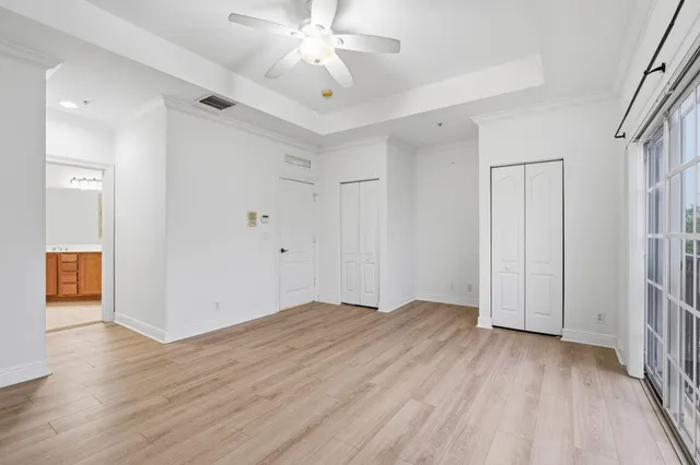 a view of an empty room with wooden floor