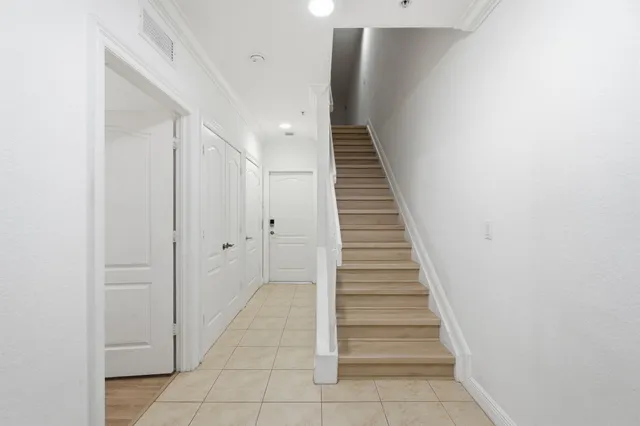 a view of entryway and hall with wooden floor