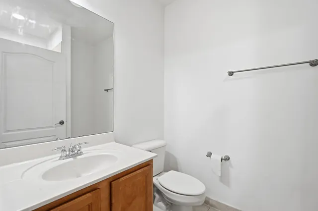 a bathroom with a sink toilet and vanity