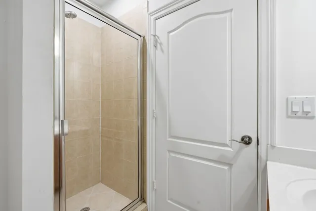 a bathroom with a glass shower door