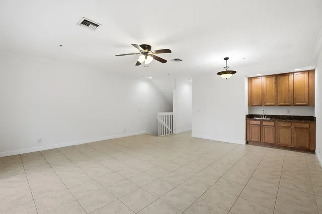 a view of a kitchen with a sink and dishwasher a kitchen island with wooden floor
