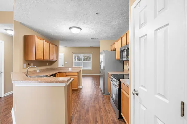 a view of a kitchen with a sink dryer and washer