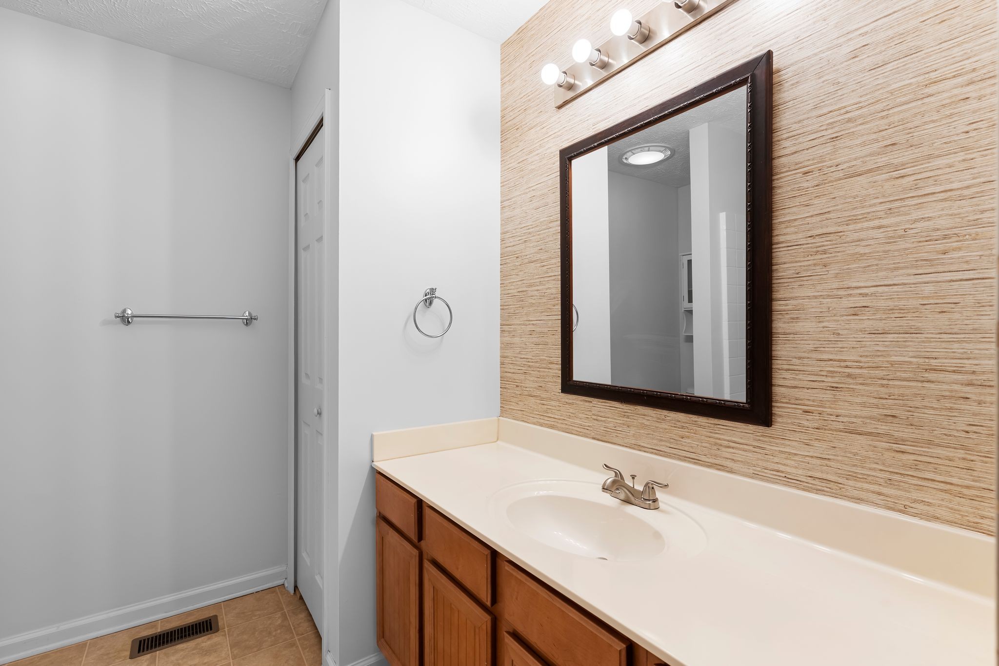 1000 Wells Way Spring Hill, TN 37174 - Photo 20 of 36 a bathroom with a sink vanity and a mirror
