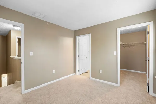 a view of an empty room and closet area